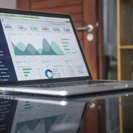 A laptop showing a monitoring dashboard with charts