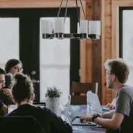 Colleagues in discussion around a meeting table
